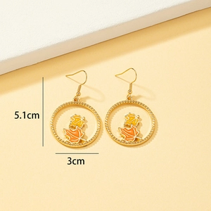 Golden geometric hoop earrings with orange and yellow enamel maple leaf charms