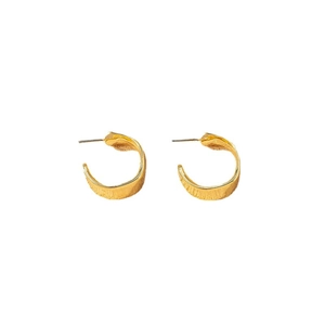 Minimalist gold alloy C-shaped hoop earrings with a textured hammered finish on white background