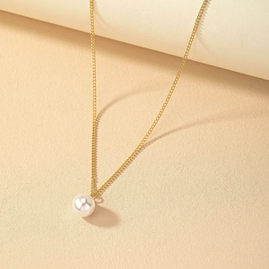 Elegant minimalist gold chain necklace featuring a single round white pearl pendant