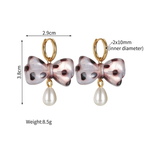 Detail view of leopard print bow earrings with drop pearls and dimensions in cm