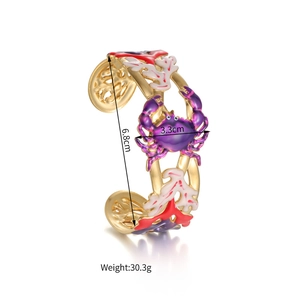 Detail showing 6.8cm inner diameter and 3.3cm width of a gold crab bangle bracelet