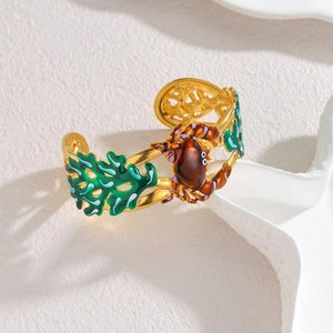 Gold-plated 18k stainless steel cuff bracelet featuring crab and green coral ocean motifs