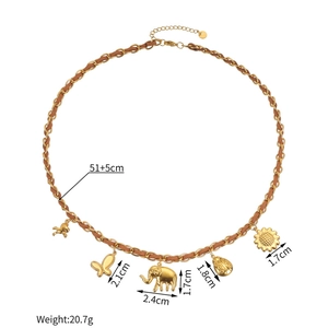 Detailed view of woven gold chain with horse, butterfly, elephant, and floral pendants