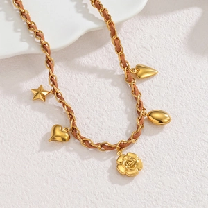 Luxurious stainless steel sweater necklace with rose and heart charms on woven leather chain