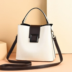Minimalist beige and brown bucket bag with square buckle and adjustable shoulder strap