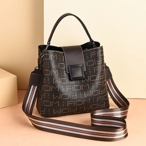 Brown leather bucket bag with monogram print and striped canvas shoulder strap