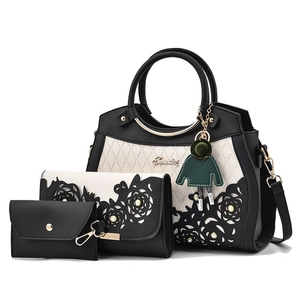Three-piece women's handbag set with hollow petal pattern and pearl accents in monochrome
