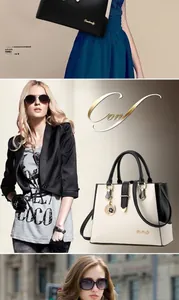 Detailed view of bicolor PU leather handbag featuring gold logo and metallic pendant