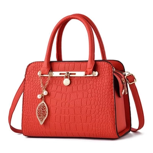 Elegant red stone pattern handbag with crocodile texture and golden leaf pendant decor