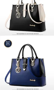 Detail of lychee pattern leather handbag with golden floral charm and elegant stitching