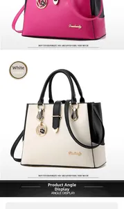Detail view of stylish PU leather handbags in rose pink and white with heart charms