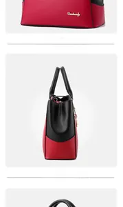 Detail view of red and black PU leather handbag with gold logo and metal chain charm