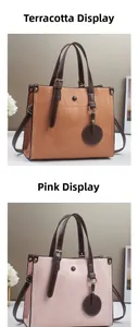 Detail view of contrast leather tote bags with geometric patchwork and detachable straps