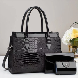 Detailed set of black patent leather tote, clutch, and card holder with crocodile pattern