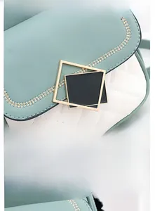 Detailed macro view of mint green quilted PU leather bag with gold wheat embroidery