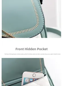 Detail of mint green shoulder bag featuring a front pocket with magnetic snap for phone storage
