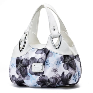 Chic women's tote bag featuring white leather contrast and elegant floral prints