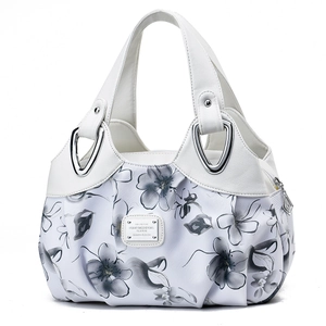 Chic color-block tote bag with artistic black floral patterns on white PU leather
