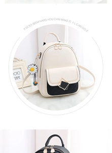 Detail of a chic quilted front pocket and daisy charm on a beige shoulder backpack