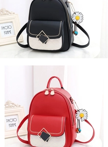 Close-up of stylish backpacks with V-stitching, metal buckles and daisy charms