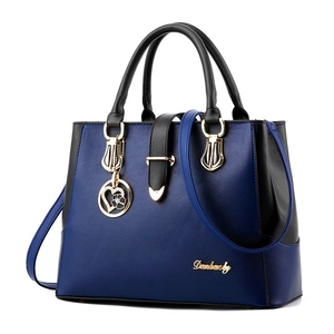 Fashion dual-color PU leather handbag with gold hardware and heart flower pendant