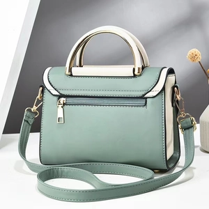 Modern mint green and cream white contrast leather crossbody bag with golden hardware details