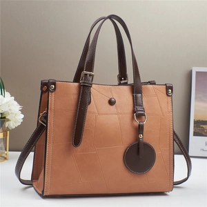 Women's patchwork faux leather tote bag with dual handles and detachable shoulder strap