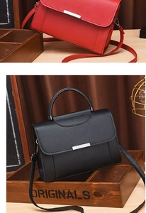 Detail of elegant red and black leather handbags with silver rectangular metal buckles