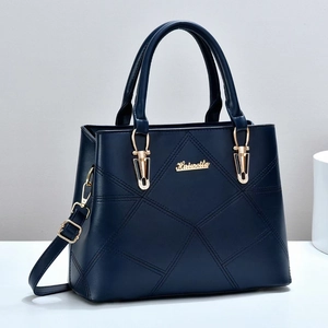 Navy blue faux leather tote bag with geometric quilting and gold logo detail