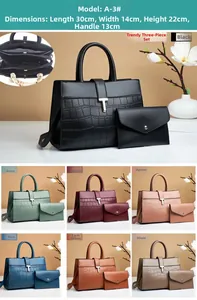 Detail of solid color tote with crocodile texture, metal T-buckle, and multi-compartment interior