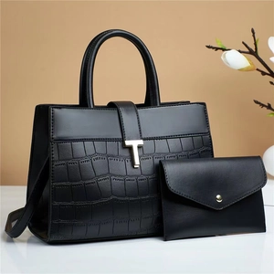 Chic black crocodile embossed leather handbag and wallet set with elegant gold hardware
