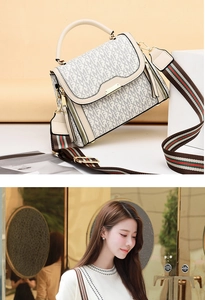 Detail of cream crossbody bag with FXMF pattern, green-red stripe strap, and gold hardware