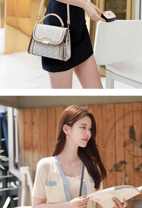 Detail view of chic monogram handbag with leather handles and metallic hardware accents