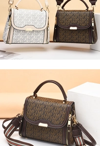 Detail of crossbody bag with printed monogram pattern and striped wide shoulder strap