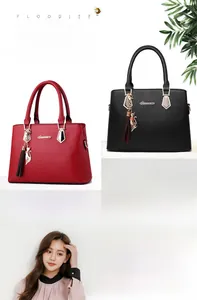 Detail of elegant PU leather tote bags with cat tassel charm and golden hardware
