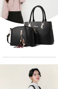Macro shot of litchi texture leather tote and crossbody bag with cat tassel charm