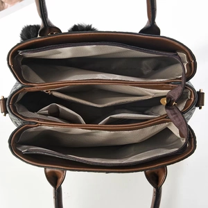 Women's handbag with spacious multi-compartment interior and pom-pom charm