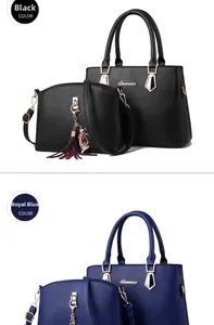 Detail of royal blue and black faux leather tote bag set with cute cat tassel pendant