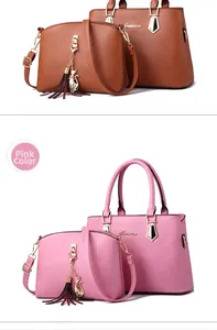 Detail view of pink and brown textured faux leather handbags with gold cat charm