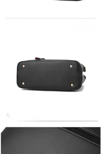 Detail of black pebbled leather handbag base featuring four gold protective metal studs