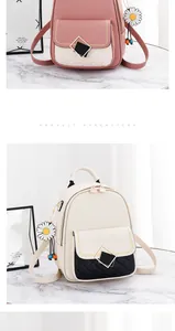 Detail of color-block PU leather backpacks with diamond quilting and flower pendants