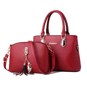 Two-piece red fashion tote bag and crossbody set with gold hardware and tassel charm