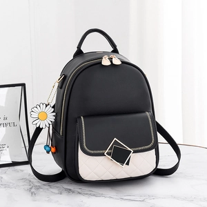 Fashionable black leather women's backpack with white quilted pocket and daisy pendant