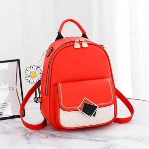 Red leather backpack with white diamond quilted pocket and daisy floral charm accessory