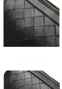 Detail of woven black leather texture and premium gold zipper on a soft shoulder bag