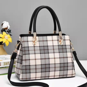 Classic plaid tote bag with black handles and gold hardware shown from a 45-degree angle
