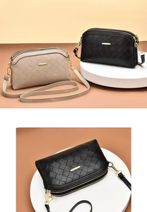 Detail of dual zipper compartments and quilted leather texture on crossbody bag