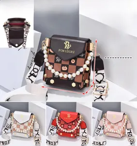 Detail view of plaid print crossbody bag with pearl chain and dual interior compartments