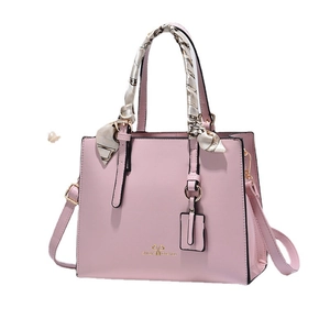 Pink faux leather tote bag with printed silk scarf handle and golden hardware detail