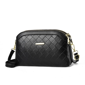 Fashionable black woven leather crossbody bag with dual golden zippers and quilted texture